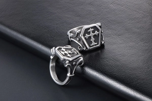 Macro view of vintage Gothic coffin ring with cross engraving on black leather