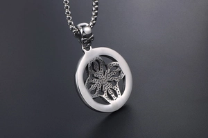 Macro view of stainless steel round pendant with skull clasp and boxed chain detail