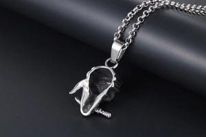 Macro view of punk style stainless steel skull pendant with textured silver finish
