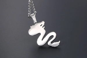 Close-up of matte dragon pendant with brushed metal texture and chunky chain