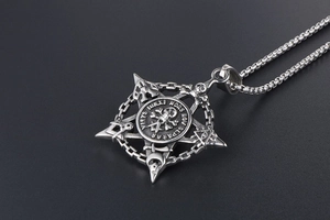 Detailed macro of vintage stainless steel skull and pentagram pendant with occult symbols