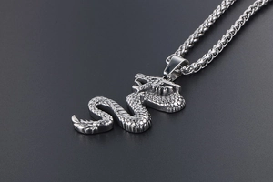 Detailed close-up of a vintage titanium steel dragon pendant with scale textures