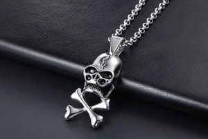 Macro shot of silver skull and crossbones pendant with gothic blackened details on leather