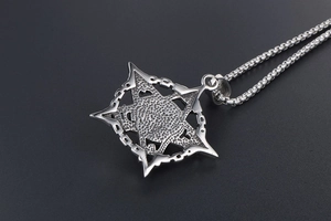 Macro shot of silver punk star pendant reverse with hammer texture and box chain
