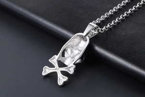 Macro shot of silver skull pendant reverse side and textured hollow punk metal finish