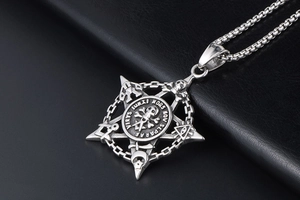 Detailed close-up of vintage steel skull pendant with engraved Masonic memento mori symbols