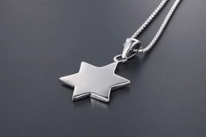 Macro shot of polished silver hexagram star pendant with sleek box chain detail