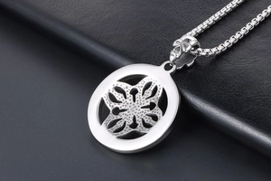 Macro shot of a vintage titanium steel pendant featuring a skull clasp and geometric petals