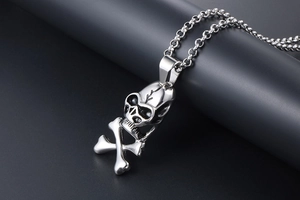 Macro view of a silver skull and crossbones pendant with vintage punk metal texture