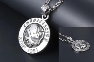 Macro detail of gothic skull pendant with 1991 engraving on polished stainless steel