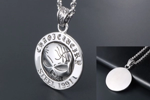 Macro detail of vintage 1991 skull pendant showing front engraving and smooth steel back