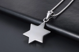 Detailed close-up of a silver hexagram star pendant on a box chain over black leather