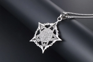 Close-up of vintage punk skull and star embossed pendant on industrial bead chain