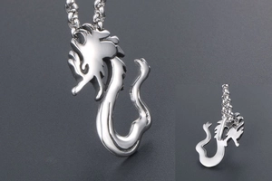 Close-up of a silver dragon pendant with polished mirror finish and circular link chain