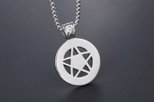 Macro shot of stainless steel pentagram star pendant with textured bail and box chain