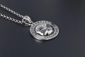 Detailed macro view of vintage 1991 skull pendant with Creed Lucifer Steel engravings