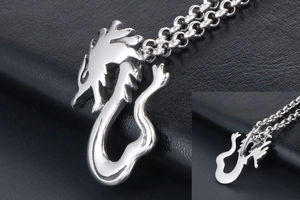 Detailed close-up showing both sides of a polished silver dragon pendant on black leather
