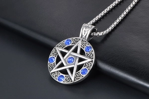 Macro shot of silver star pendant with six blue crystals and Celtic knot details