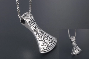 Detailed view of Viking battle axe pendant with intricate Celtic knots and beaded chain
