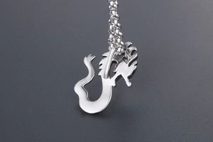 Macro view of a polished silver dragon pendant with detailed dragon scales and link chain