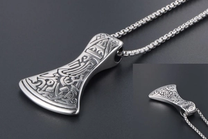 Detailed macro view of the intricate Viking axe pendant and stainless steel box chain