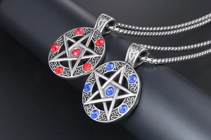 Macro shot of retro star pendants with red and blue crystals and steel bead chains