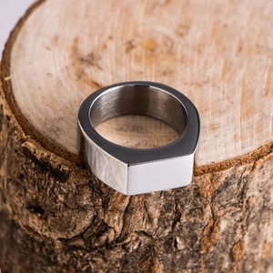 Close-up of polished silver signet ring for men with rectangular flat top surface