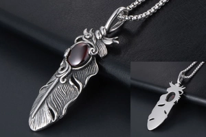 Detailed macro shot of a vintage titanium steel feather pendant with a ruby zircon inlay
