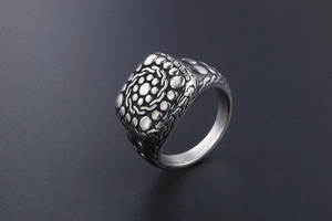 Detailed side view of vintage titanium steel ring with cobblestone relief texture
