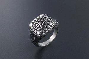 Macro view of vintage titanium steel ring with textured pebble pattern and relief dots