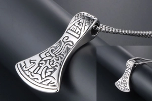Macro detail of Nordic Viking axe pendant with intricate textures and stainless steel chain