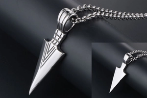 Close-up of a silver triangle titanium steel arrow pendant with geometric grooved details