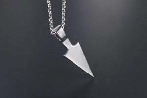 Macro detail of polished triangular titanium steel pendant with sleek metallic finish