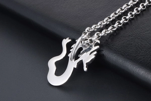 Macro close-up of the polished silver dragon pendant and O-chain texture details