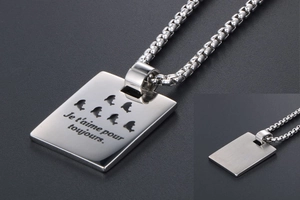 Detailed shot of titanium steel rectangular tag with French engraving and box chain