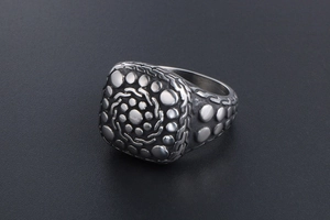 Macro shot of vintage titanium steel ring featuring an embossed pebble texture finish