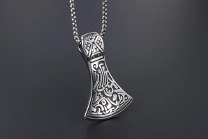 Detailed view of silver stainless steel axe pendant with intricate Viking textures and box chain