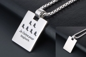 Macro view of men's titanium steel military pendant with French engraved box chain