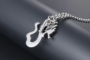 Macro detail of the polished silver dragon pendant back and sturdy ball chain link