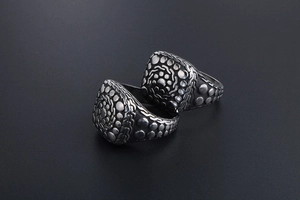 Macro shot of retro titanium steel ring featuring pebble texture and antique silver finish