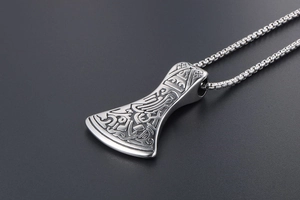 Macro shot of Viking axe pendant featuring Celtic knot engravings on stainless steel