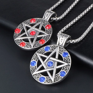 Pentagram star couple necklaces with red and blue gemstones on black leather background