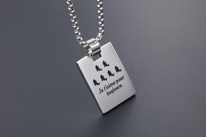 Detail of titanium steel rectangle pendant with French Je t'aime pour toujours engraving