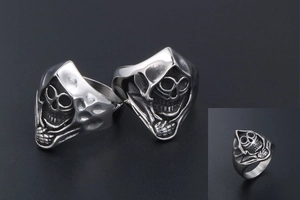 Macro shot of gothic hooded skull relief on vintage silver titanium steel ring