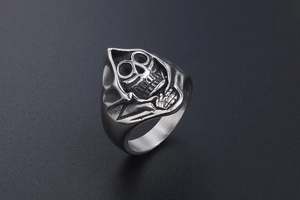 Macro detail of gothic grim reaper ring with vintage silver and black brushed steel finish