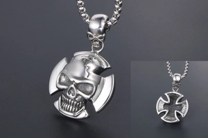 Macro shot of punk skull pendant with cross base and detailed vintage silver texture