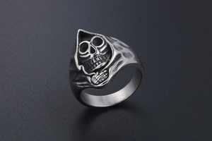 Macro shot of gothic reaper skull ring with hammered texture in vintage steel