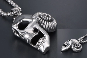 Macro detail of gothic ram skull pendant with textured horns and distressed silver finish