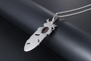 Detailed close-up of a silver feather pendant with an oval red ruby stone inlay