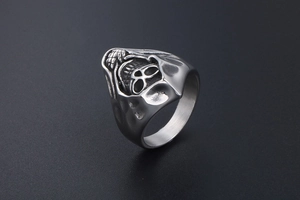 Macro detail of vintage gothic skull ring with hooded grim reaper design in silver steel